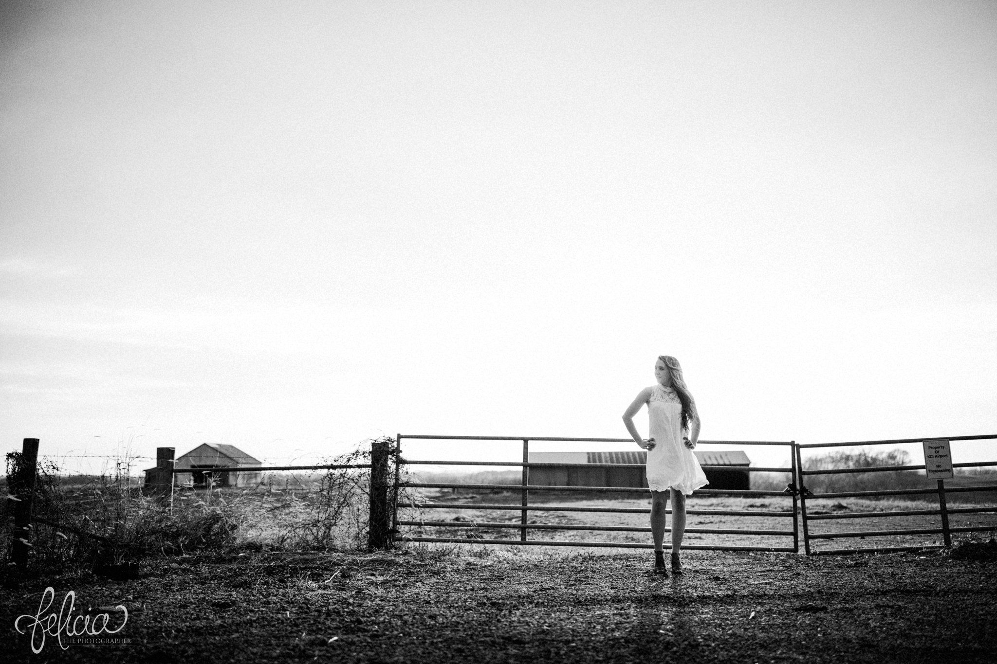 senior pictures | images by feliciathephotographer.com | Kansas City | rustic | long blonde hair | nature background | farm house | white dress | elegant | dramatic | black and white | farm pictures | fences 