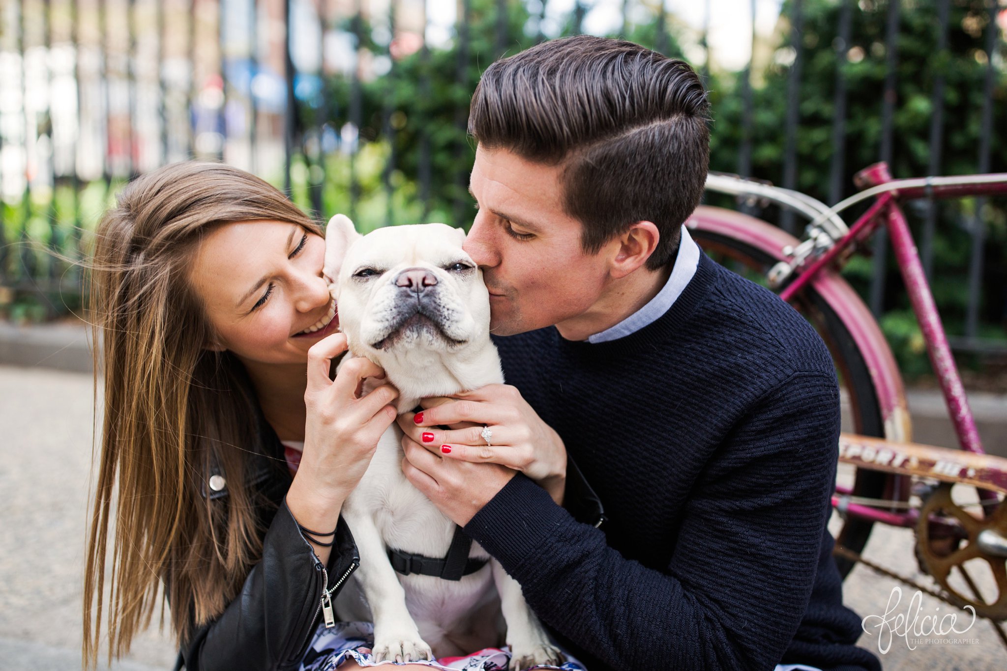kissing dog | laughing bride and groom | engagement ring | smiling bride and groom | close up | diamond ring | red fingernails with engagement ring | New York City Photography | wedding | New York City | West Village | New York City photography | wedding photography | images by feliciathephotographer.com | French Bulldog | engagement photos | engagement pictures with dog | engagement pictures in park | vintage bicycle | red bicycle 