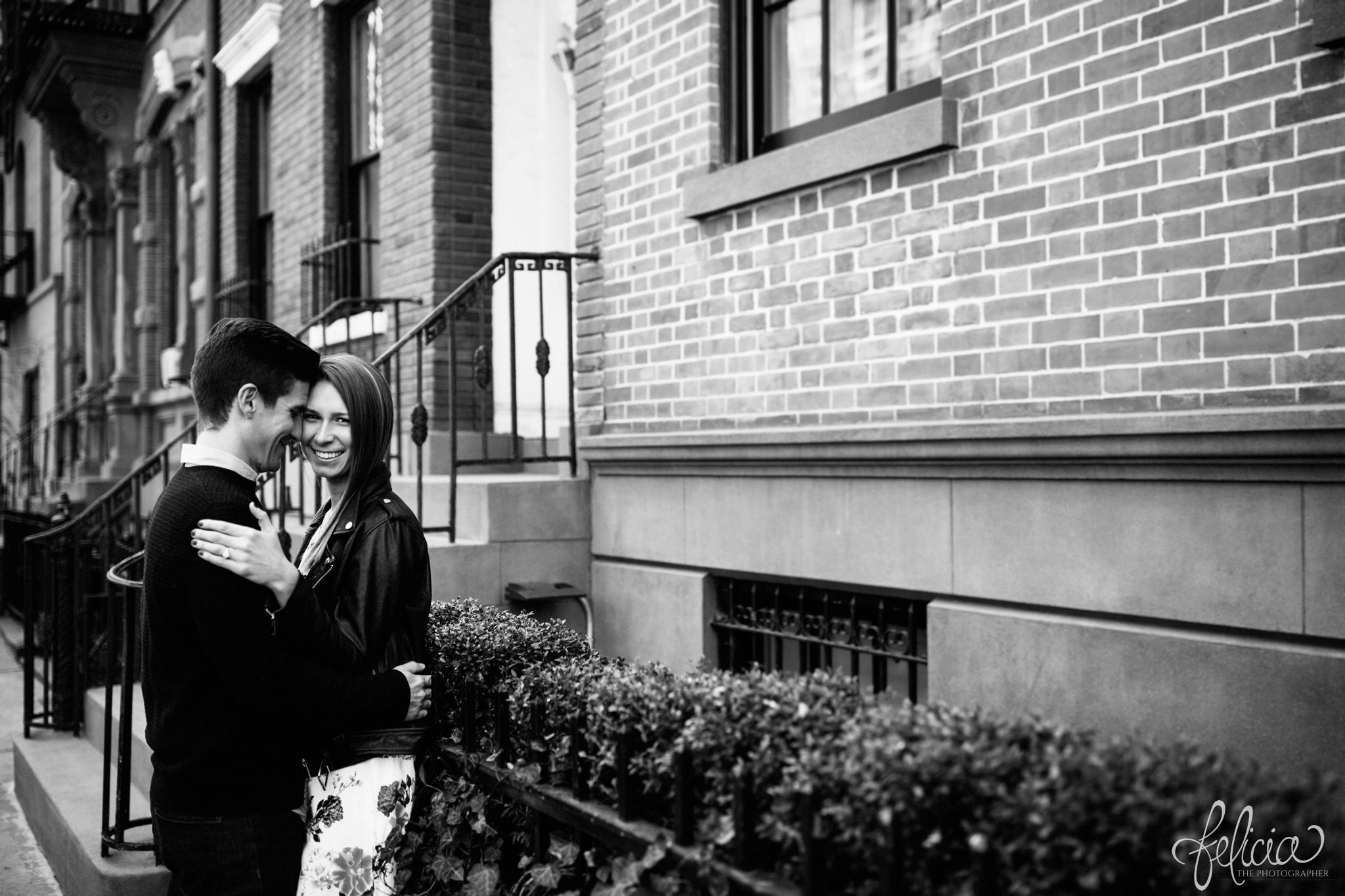 wedding | New York City | West Village | New York City photography | wedding photography | images by feliciathephotographer.com | engagement photos | engagement pictures in New York City | candid | romantic engagement pictures | black and white | brick background | engagement ring | bride looking at camera | groom looking at bride 