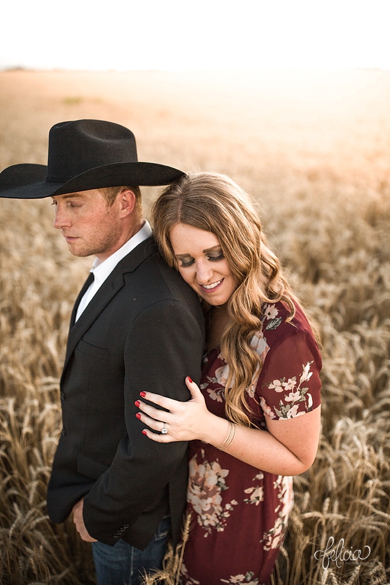 images by feliciathephotographer.com | engagement photographer | kansas farm | country | golden hour | sunset | romantic | true love | southern belle | bride to be | wheat field | cowboy hat | floral dress | sincere 
