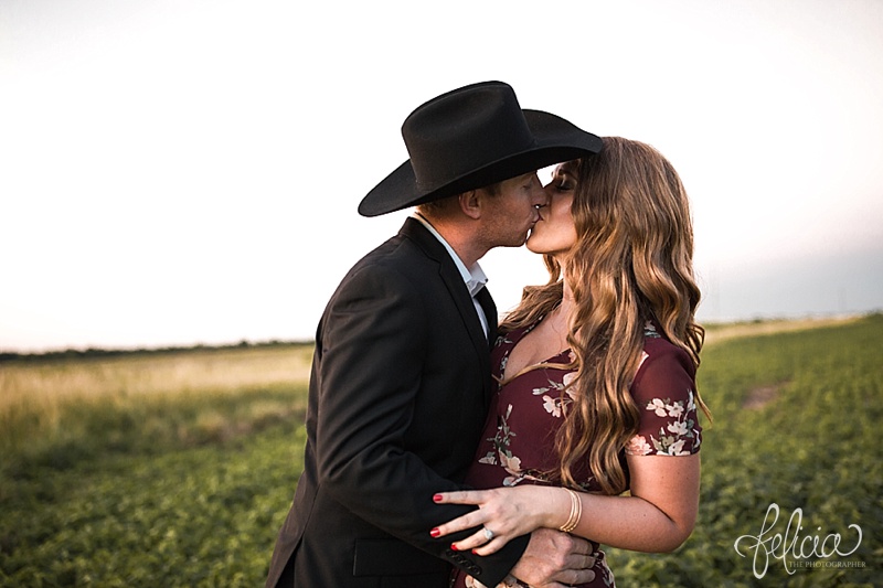 images by feliciathephotographer.com | engagement photographer | kansas farm | country | golden hour | sunset | romantic | true love | southern belle | bride to be | wheat field | cowboy hat | floral dress | diamond ring | kiss