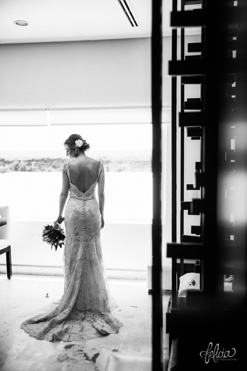 images by feliciathephotographer.com | Destination Beach Wedding | Mexico Resort | Photography | Bridal Lace Dress | Floral Bouquet | Portrait | Buttons | Hair Flower | Up-Do | Pre-Ceremony | Train | Open Back | Black and White | 