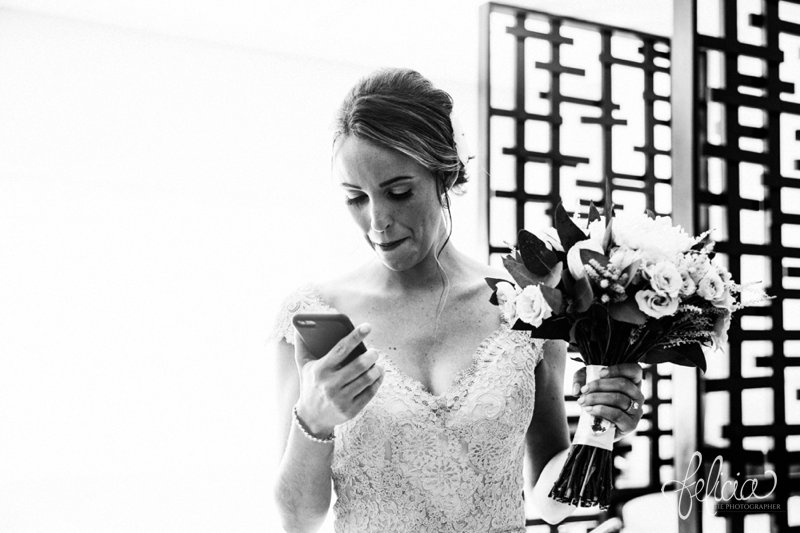 images by feliciathephotographer.com | Destination Beach Wedding | Mexico Resort | Photography | Bridal Lace Dress | Floral Bouquet | Hair Up-Do | Phone | Technology | Black and White | 