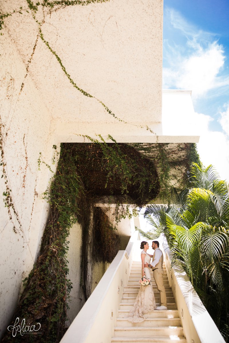 images by feliciathephotographer.com | Destination Beach Wedding | Mexico Resort | Photography | Azul Sensatori | portraits | palm trees | tropical landscaping | staircase | vines | lace dress | bride and groom | bouquet 