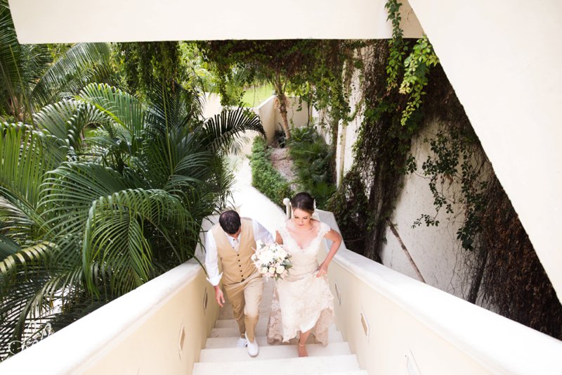 images by feliciathephotographer.com | Destination Beach Wedding | Mexico Resort | Photography | Azul Sensatori | staircase | bouquet | bride and groom | portraits | palm trees | vines | green | tan suit | lace dress | 