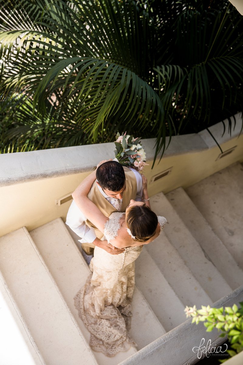 images by feliciathephotographer.com | Destination Beach Wedding | Mexico Resort | Photography | Azul Sensatori | arial view | lace dress | train | kiss | palm trees | staircase | portrait | green | pink | chic