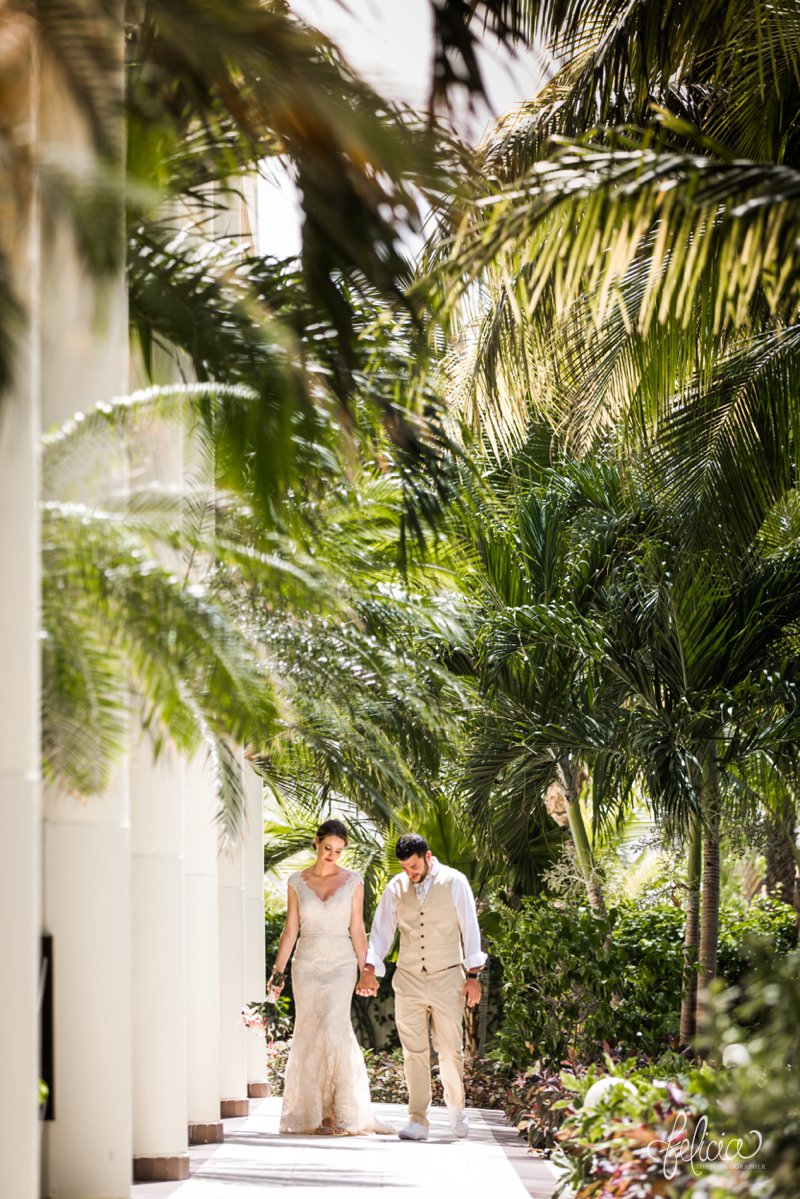 images by feliciathephotographer.com | Destination Beach Wedding | Mexico Resort | Photography | Azul Sensatori | walking | holding hands | bride and groom | palm trees | rain forest | green | tropical decor | kaki suit | lace dress |