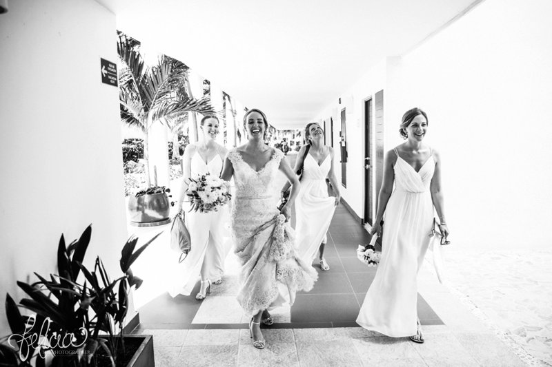 images by feliciathephotographer.com | Destination Beach Wedding | Mexico Resort | Photography | Bridal Lace Dress | Floral Bouquet | Portrait | Buttons | Hair Flower | Up-Do | Pre-Ceremony | Black and White | Bridesmaids | Laughter |  