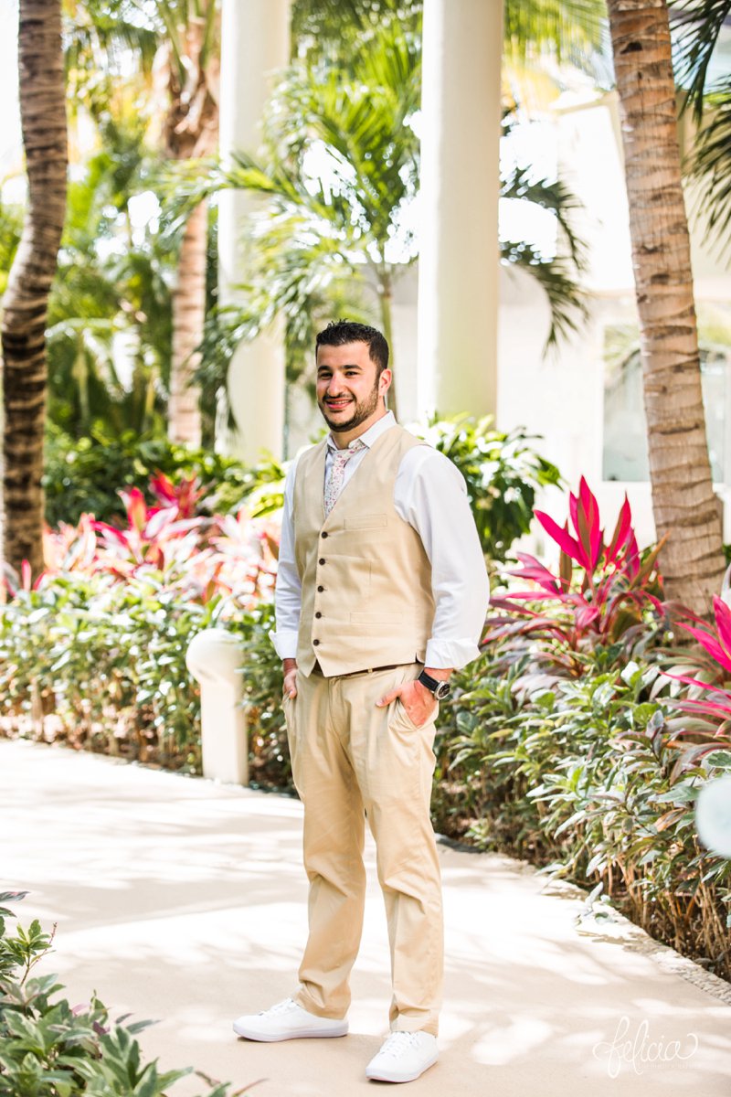 images by feliciathephotographer.com | Destination Beach Wedding | Mexico Resort | Photography | Azul Sensatori | portrait | groom | tropical decor | hot pink | tan suit | floral tie | white sneakers | pre-ceremony 