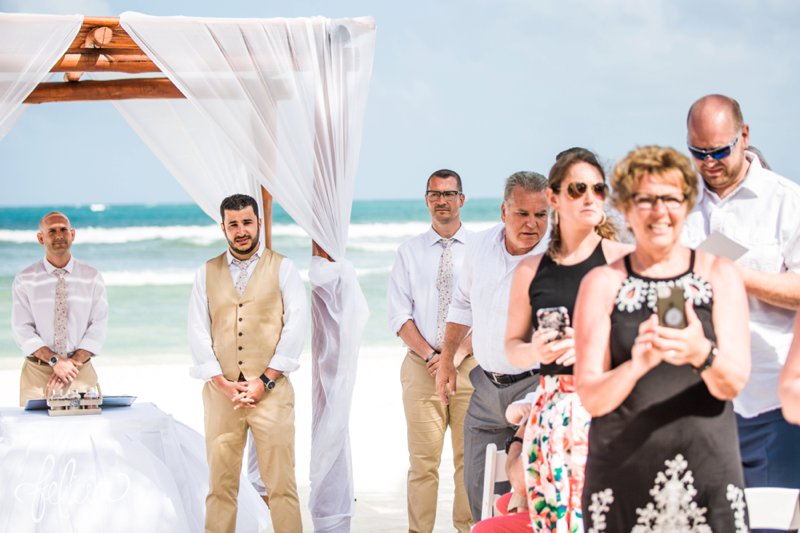 images by feliciathephotographer.com | Destination Beach Wedding | Mexico Resort | Photography | Azul Sensatori | ocean | canopy | groom | walking down the isle | waves | blue | tan suit | floral tie | pastor 