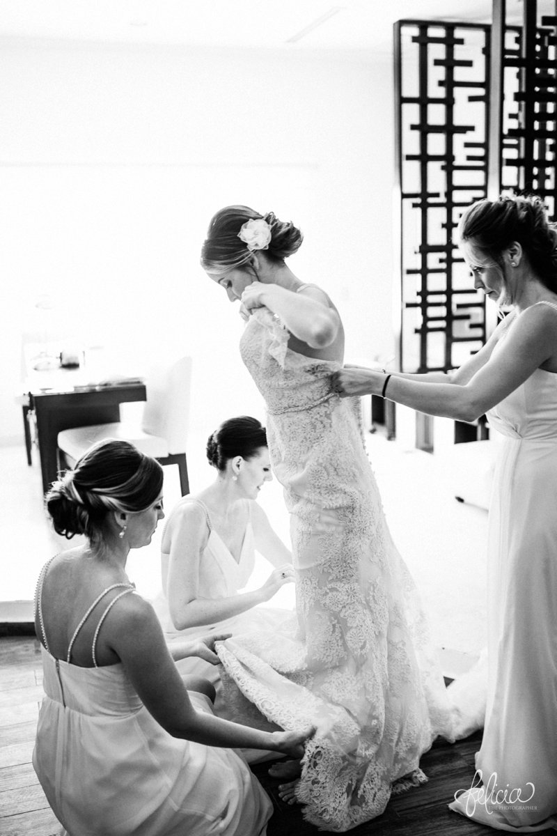 images by feliciathephotographer.com | Destination Beach Wedding | Mexico | Photography | Black and White | Getting Ready | Bridesmaids | Getting into Dress | Beading | Lace | Buttons | Hair Flower | Up-Do
