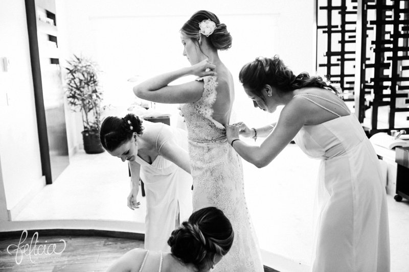 images by feliciathephotographer.com | Destination Beach Wedding | Mexico Resort | Photography | Black and White | Getting Ready | Bridesmaids | Getting into Dress | Beading | Lace | Buttons | Hair Flower | Up-Do | Details 