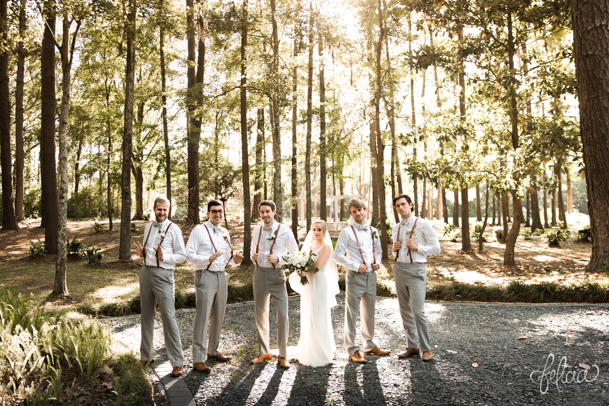 images by feliciathephotographer.com | destination wedding | the makey house | dave gibson coordinator | travel photographer | Savannah, georgia | southern | bride | groomsmen | snapping suspenders | trees | forest | green | lace dress |