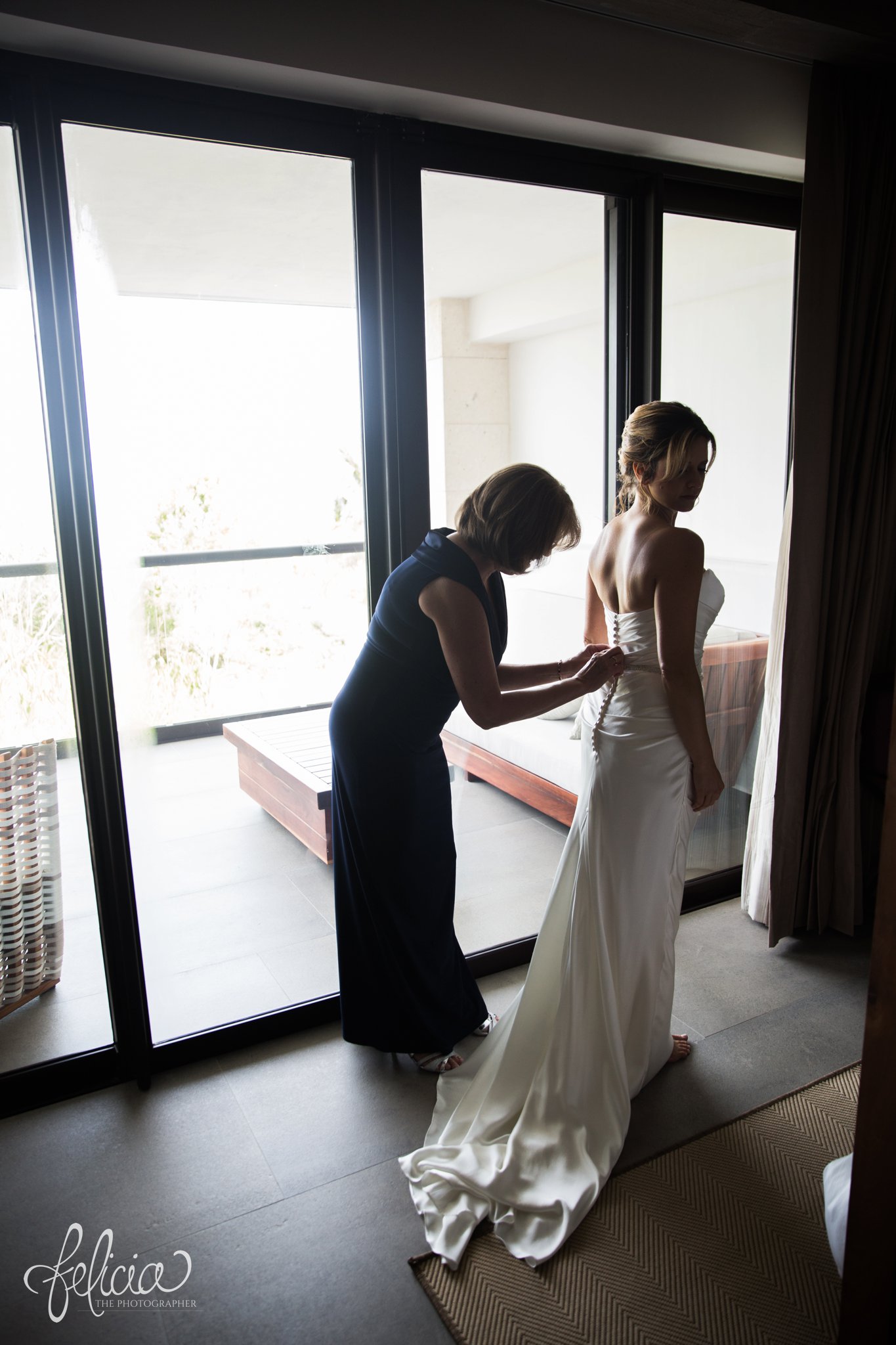 images by feliciathephotographer.com | Destination Beach Wedding | Unicco 20 87 | Photographer | L&S Travel | getting ready | putting on the dress | mother daughter | natural light | casablanca bridal | buttons | elegant 