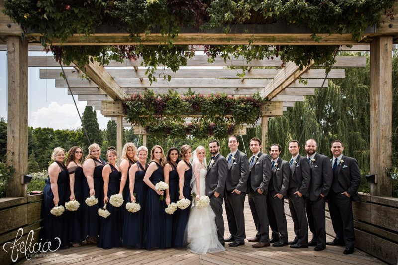 images by feliciathephotographer.com | destination wedding photographer | westin north shore | Chicago botanical gardens | portrait | bridal party | rose bouquet | greenery | wooden pergola | navy dress | lace | tule | gray suits | 