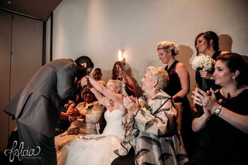 images by feliciathephotographer.com | destination wedding photographer | westin north shore | Chicago botanical gardens | bride signing | tish | bedeken | yamaka | jewish | rabi | mother | joy | laughter | lace | navy dress | groom veiling | kiss