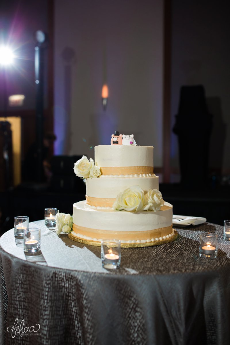 images by feliciathephotographer.com | destination wedding photographer | westin north shore | Chicago botanical gardens | cake | gold ribbon | white roses | candles | details | reception | party | celebration | cat | bear | toppers