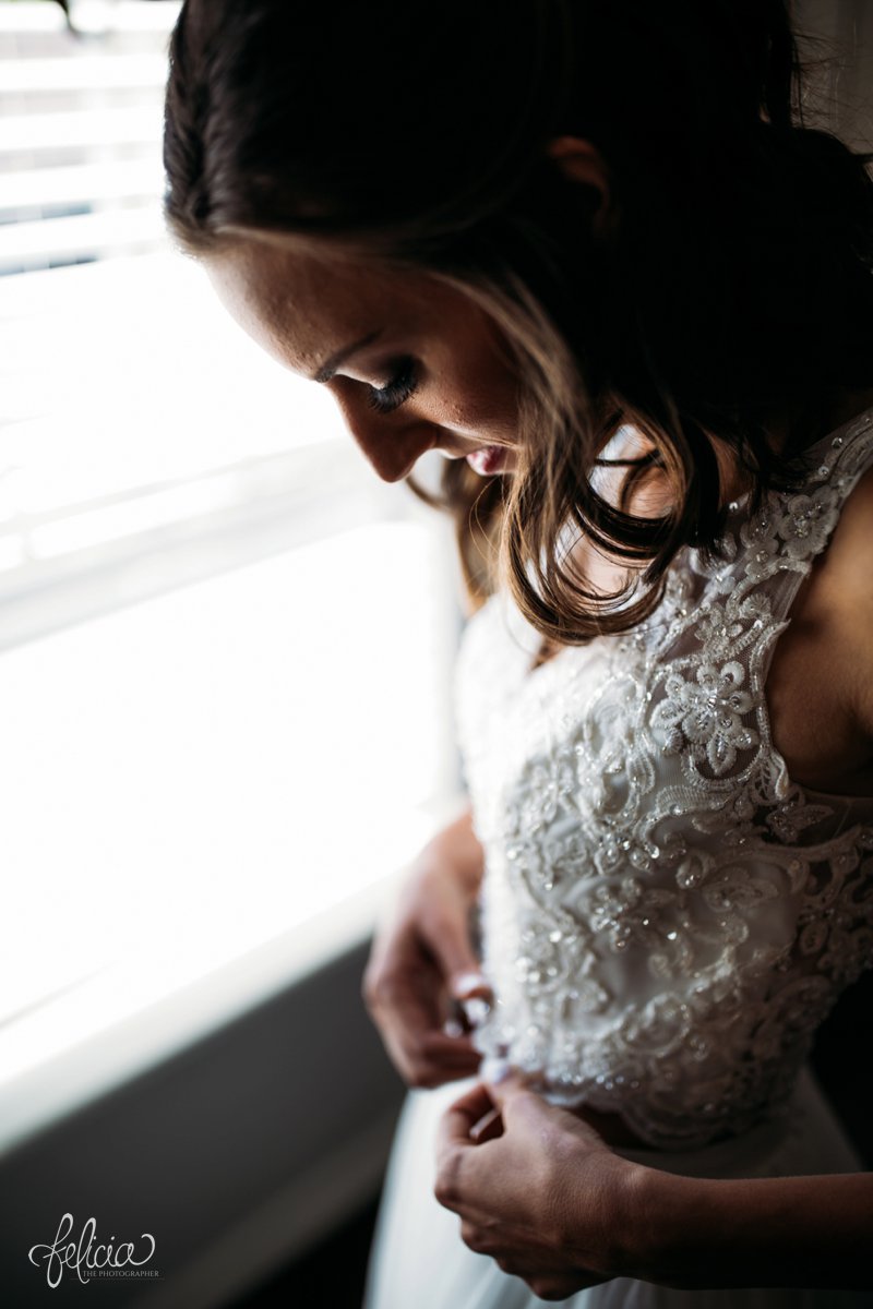 images by feliciathephotographer.com | wedding photographer | kansas city missouri | industrial | romantic | neutral | getting ready | pre-ceremony | lace dress | mia's bridal | natural light | 