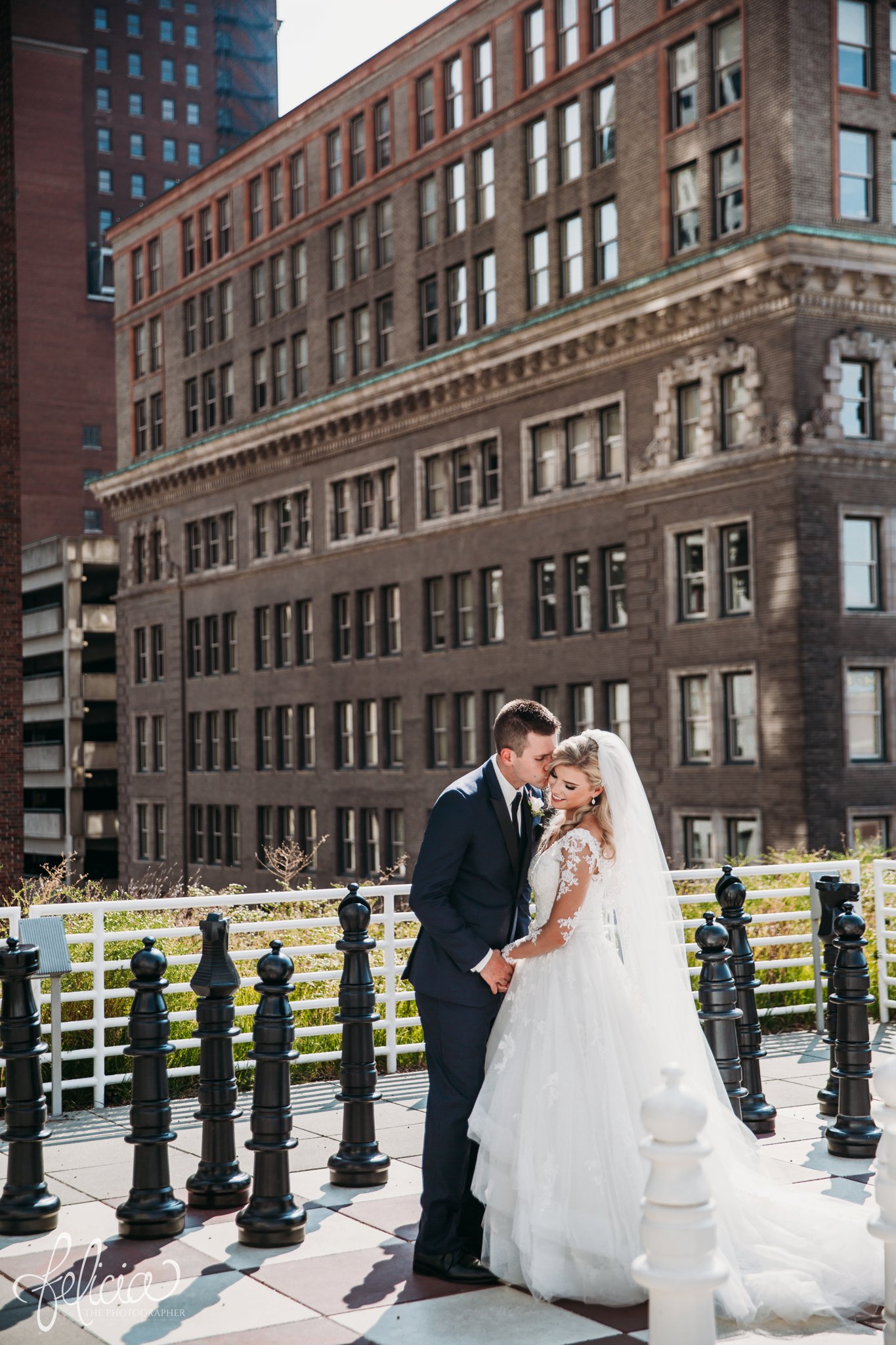 images by feliciathephotographer.com | wedding photographer | kansas city | redemptorist | classic | library | chess board | rooftop | industrial | romantic | portrait | bride and groom | lace long sleeve dress | veil | true love | 