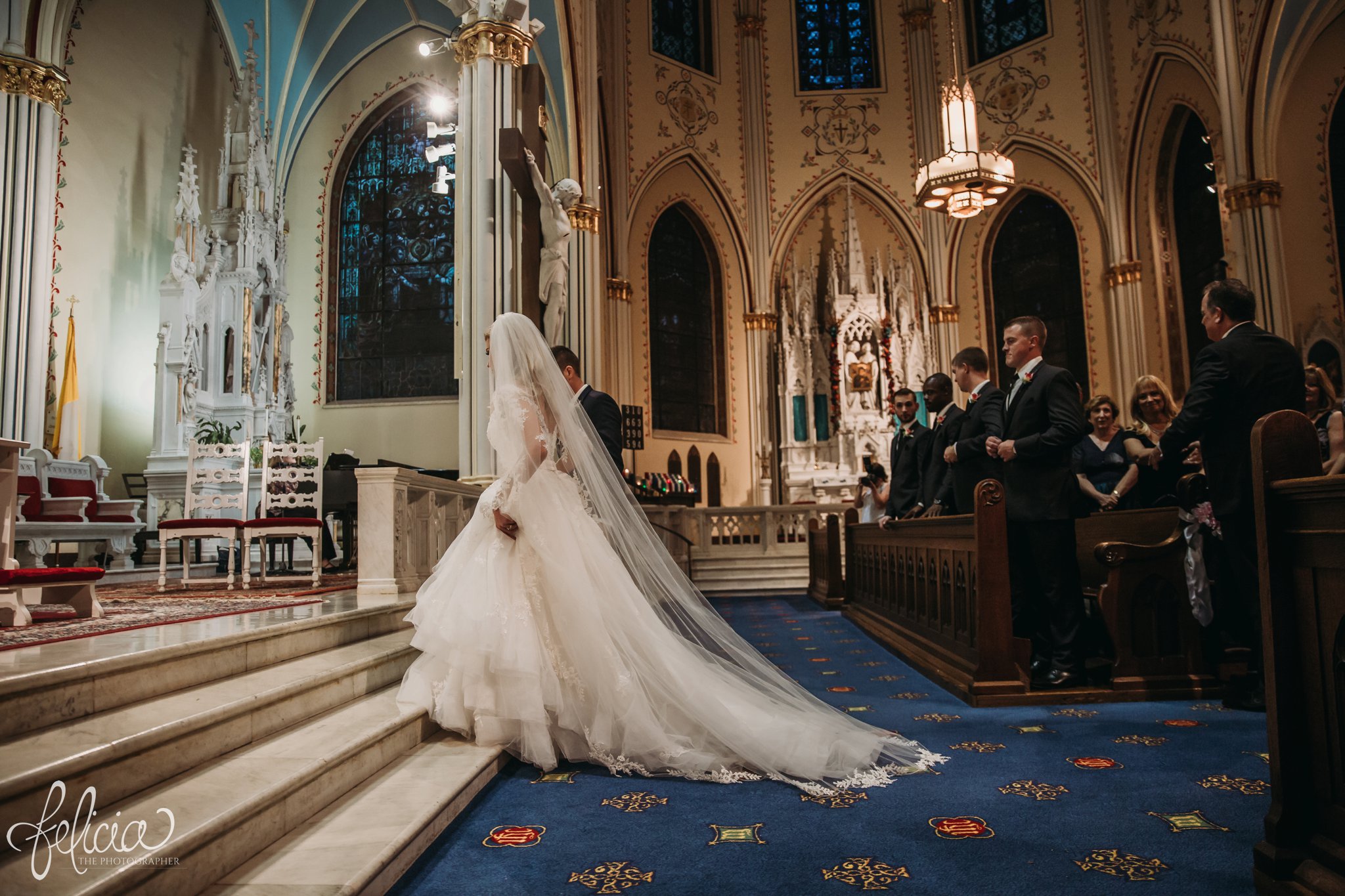 images by feliciathephotographer.com | wedding photographer | kansas city | redemptorist | classic | ceremony | bride and groom | catholic | our lady of perpetual help | long train | lace dress | flowing veil | 