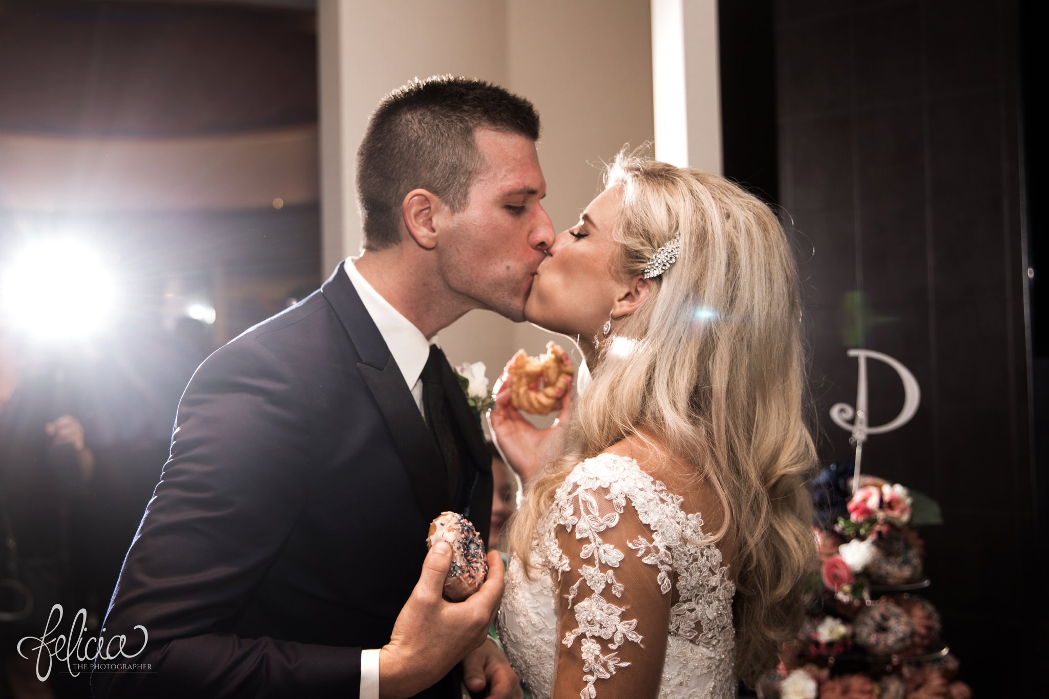 images by feliciathephotographer.com | wedding photographer | kansas city | redemptorist | classic | lace dress | reception | royal room | romantic | cutting the cake | donut king |