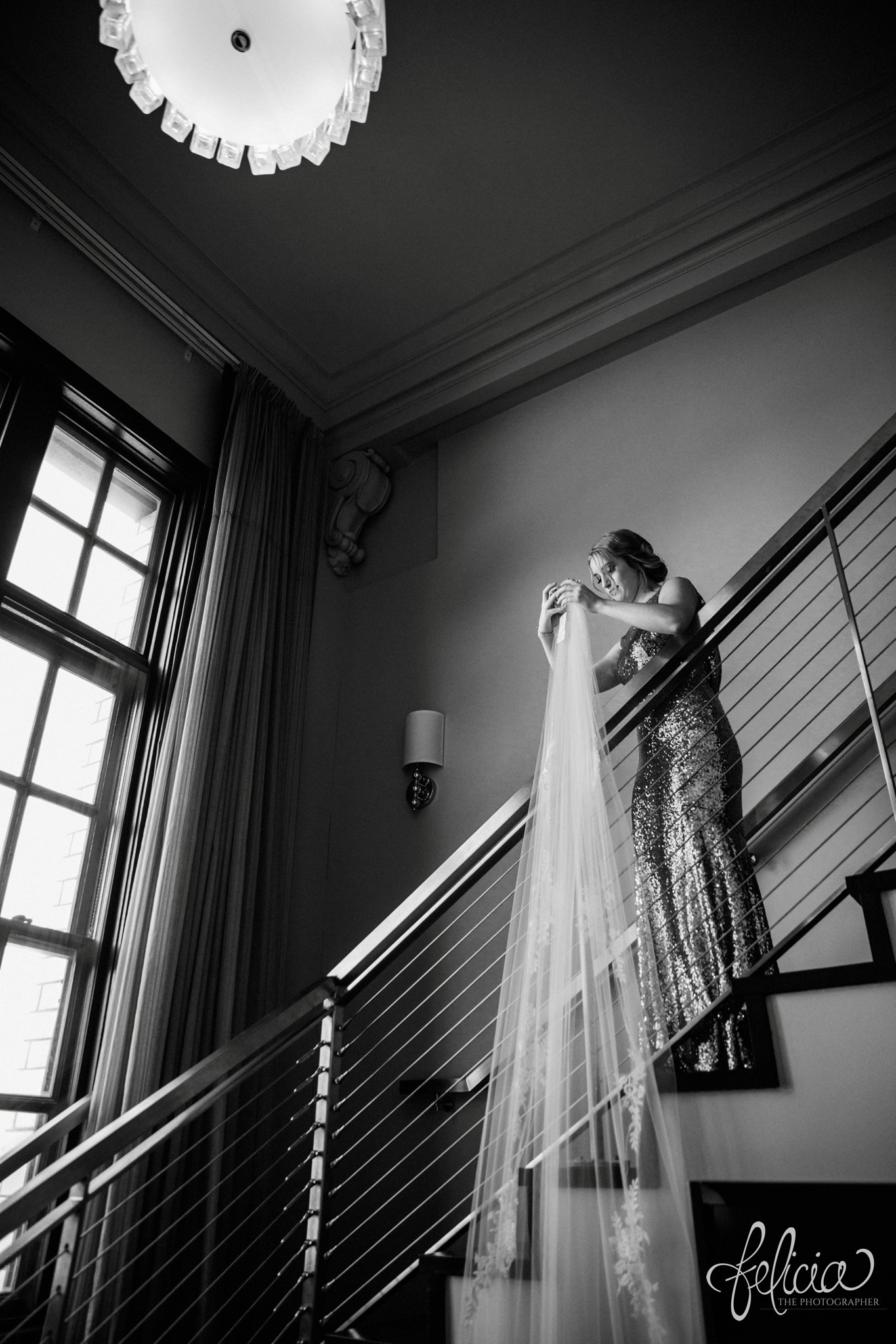 images by feliciathephotographer.com | wedding photographer | downtown kansas city | getting ready | bella bridesmaid | sequins | black and white | staircase | long lace veil | 