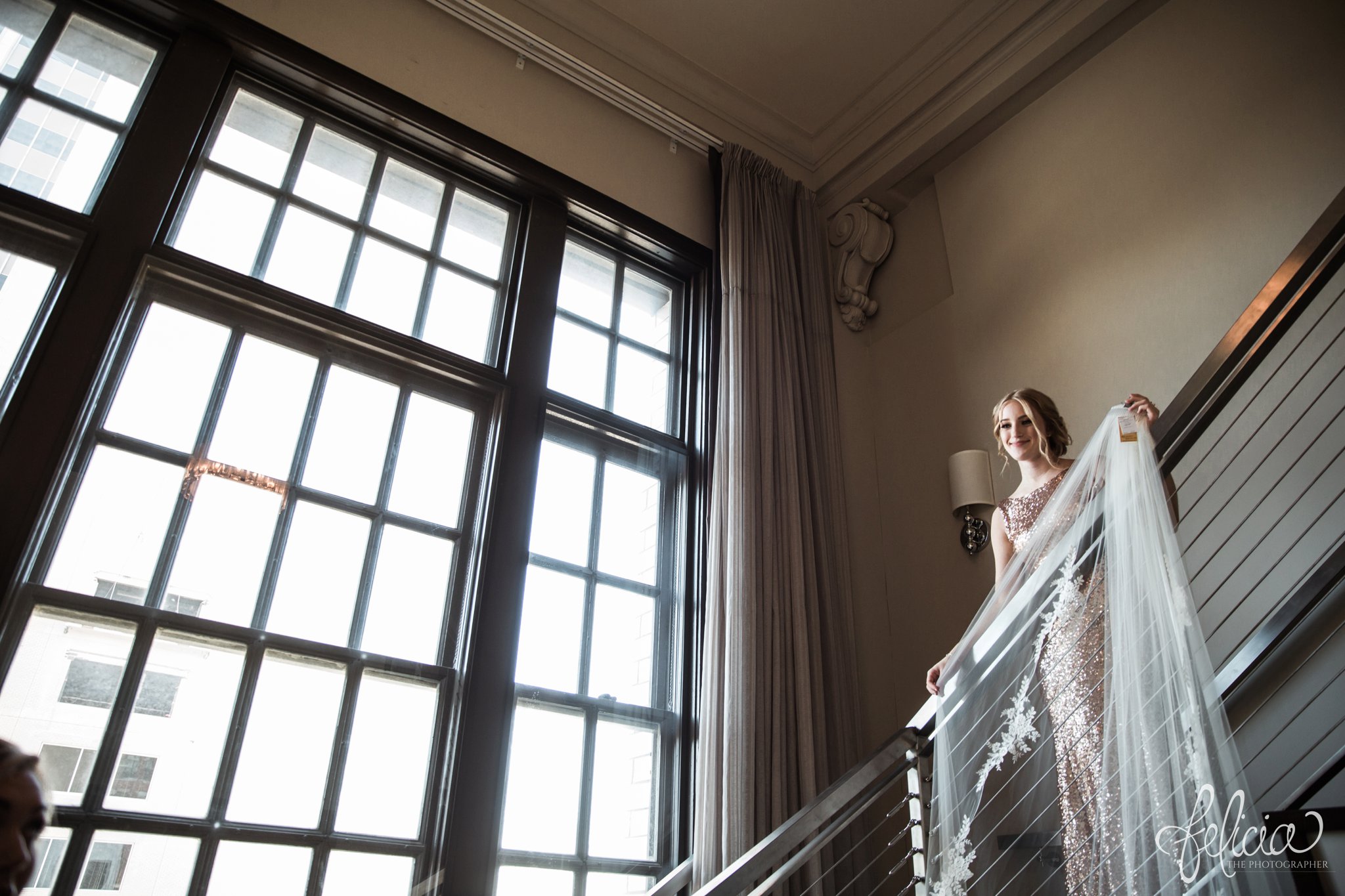 images by feliciathephotographer.com | wedding photographer | downtown kansas city | getting ready | putting on the veil | bridesmaid | sequins | bella | reaction | natural light | hotel ambassador | 