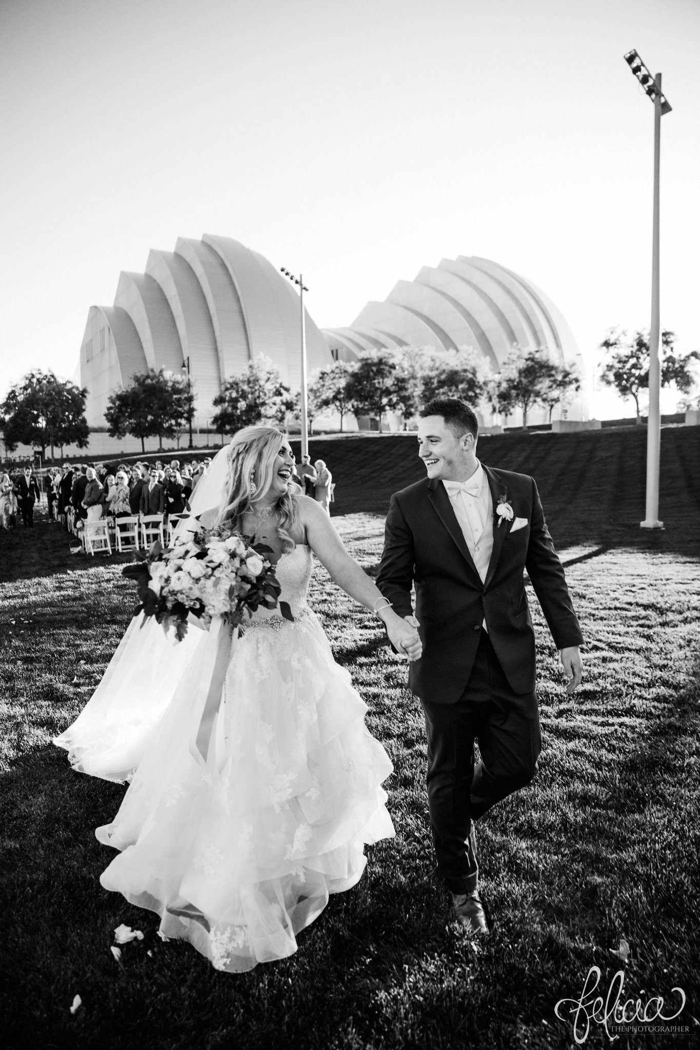 images by feliciathephotographer.com | wedding photographer | downtown kansas city | outdoor ceremony | kauffman center | the grand ballroom kc convention center | black and white | walking back down the aisle | married | bride and groom | romantic | joy | 