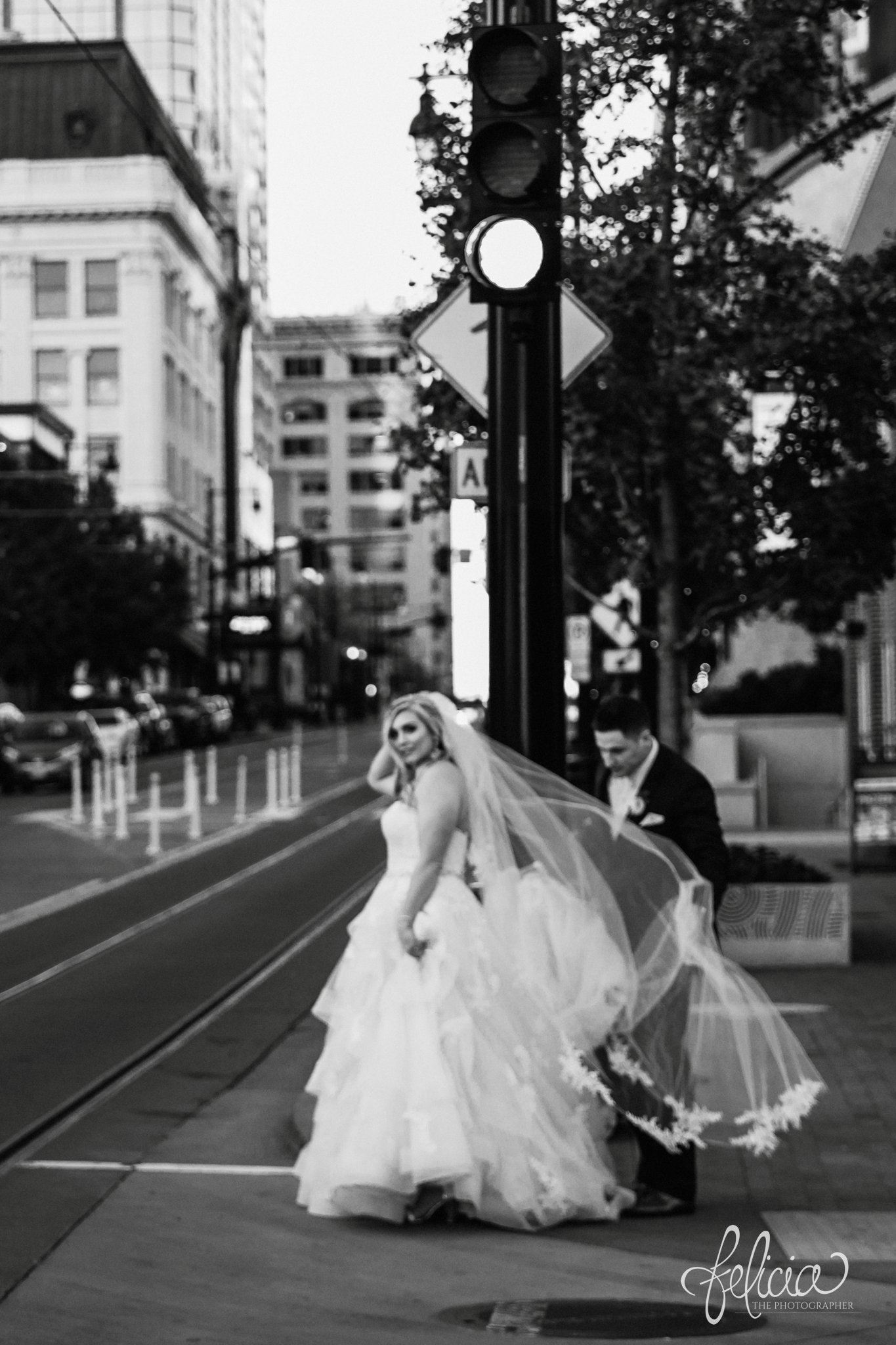 images by feliciathephotographer.com | wedding photographer | downtown kansas city | black and white | bride and groom | urban | romantic | long lace dress | belle vogue | full train | 