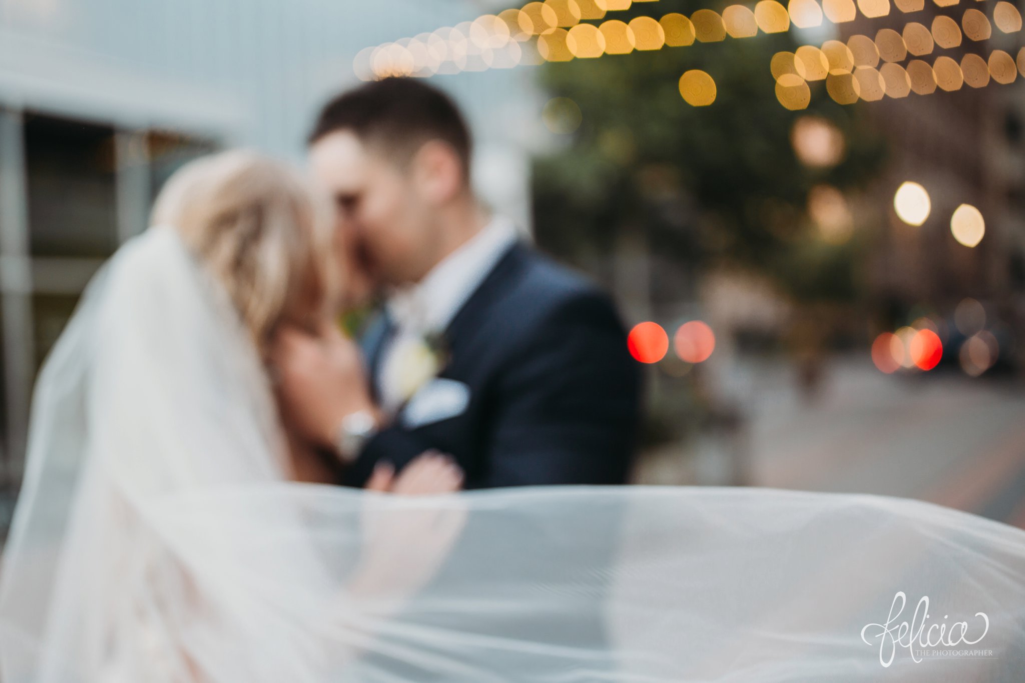 images by feliciathephotographer.com | wedding photographer | downtown kansas city | bride and groom portrait | out of focus | flowing veil | kiss | true love | string lights | romantic | glamorous | 