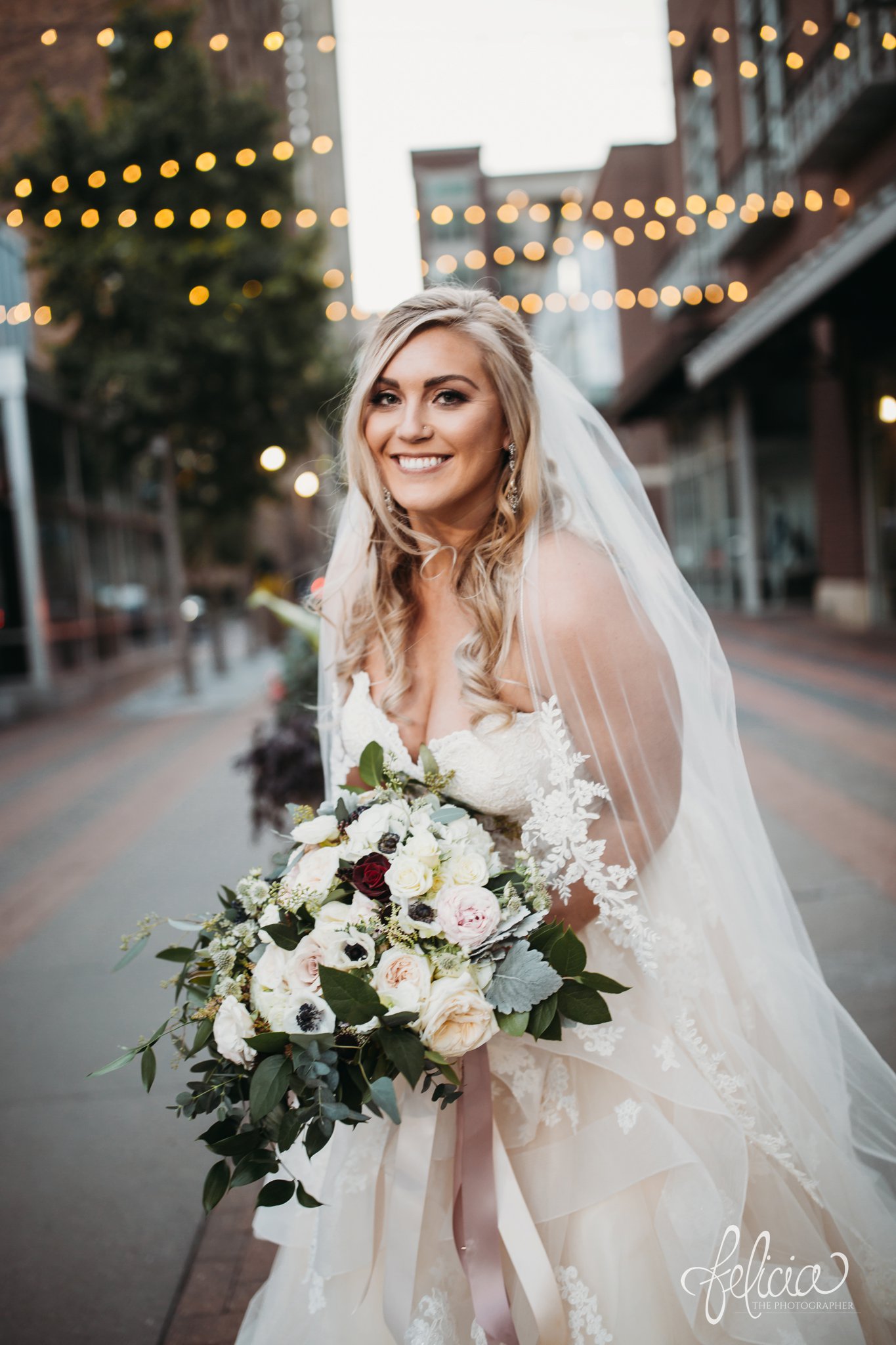 images by feliciathephotographer.com | wedding photographer | downtown kansas city | bridal portrait | sting lights | power and light | glamorous | lace dress | belle vogue | wild hill flowers | 