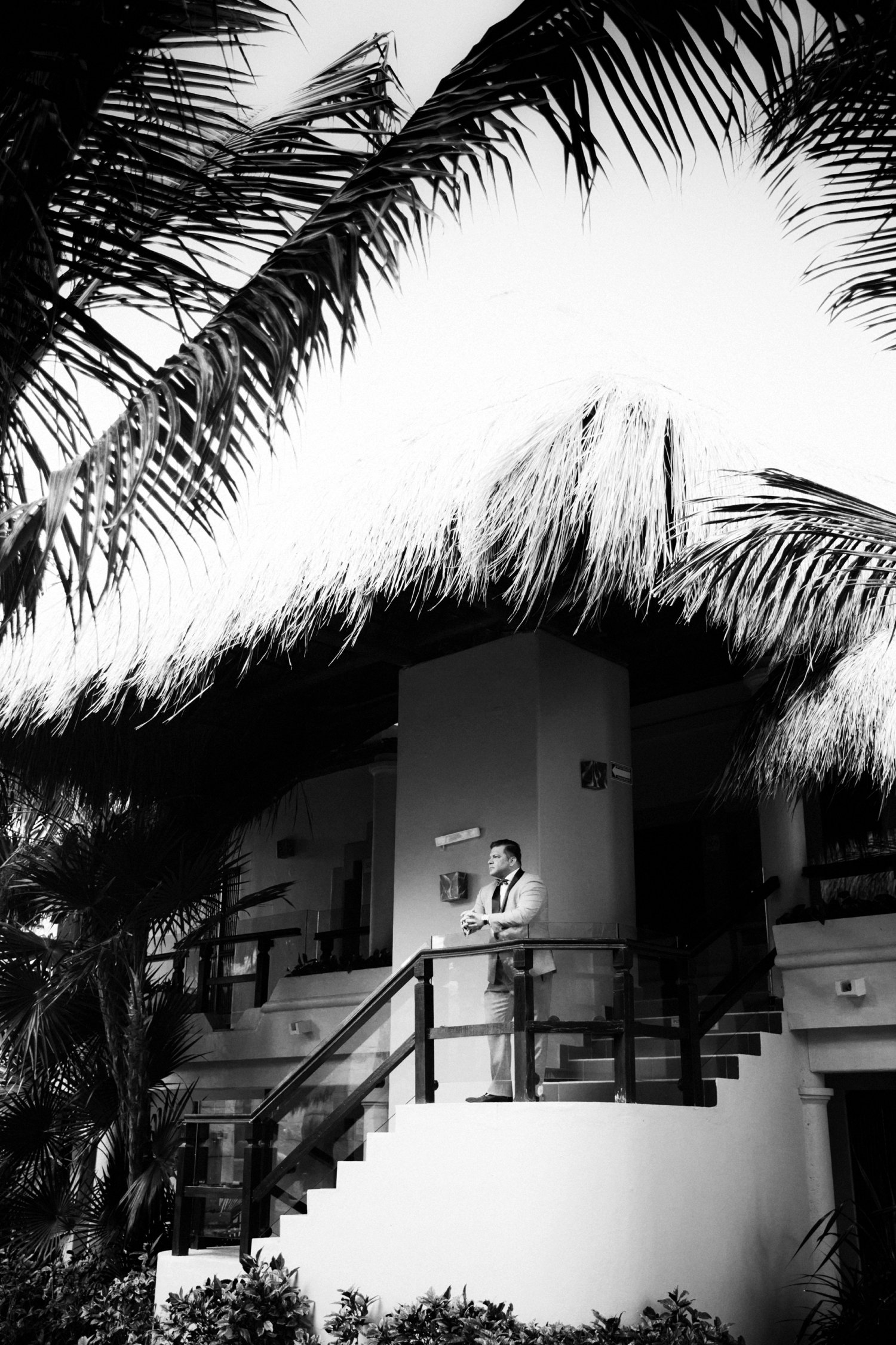  images by feliciathephotographer.com | destination wedding photographer | mexico | tropical | fiji | venue | azul beach resort | riviera maya | getting ready | details | black and white | pre-ceremony | grey suit | polka dot bow tie | palm trees |