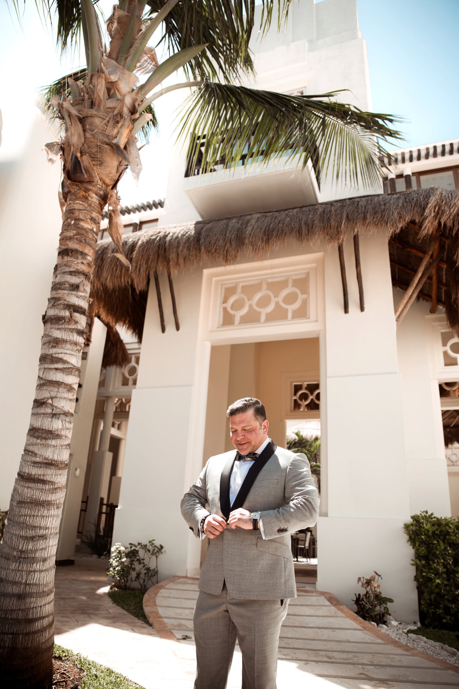  images by feliciathephotographer.com | destination wedding photographer | mexico | tropical | fiji | venue | azul beach resort | riviera maya | getting ready | details | pre-ceremony | palm trees | grey suit | black tie attire |