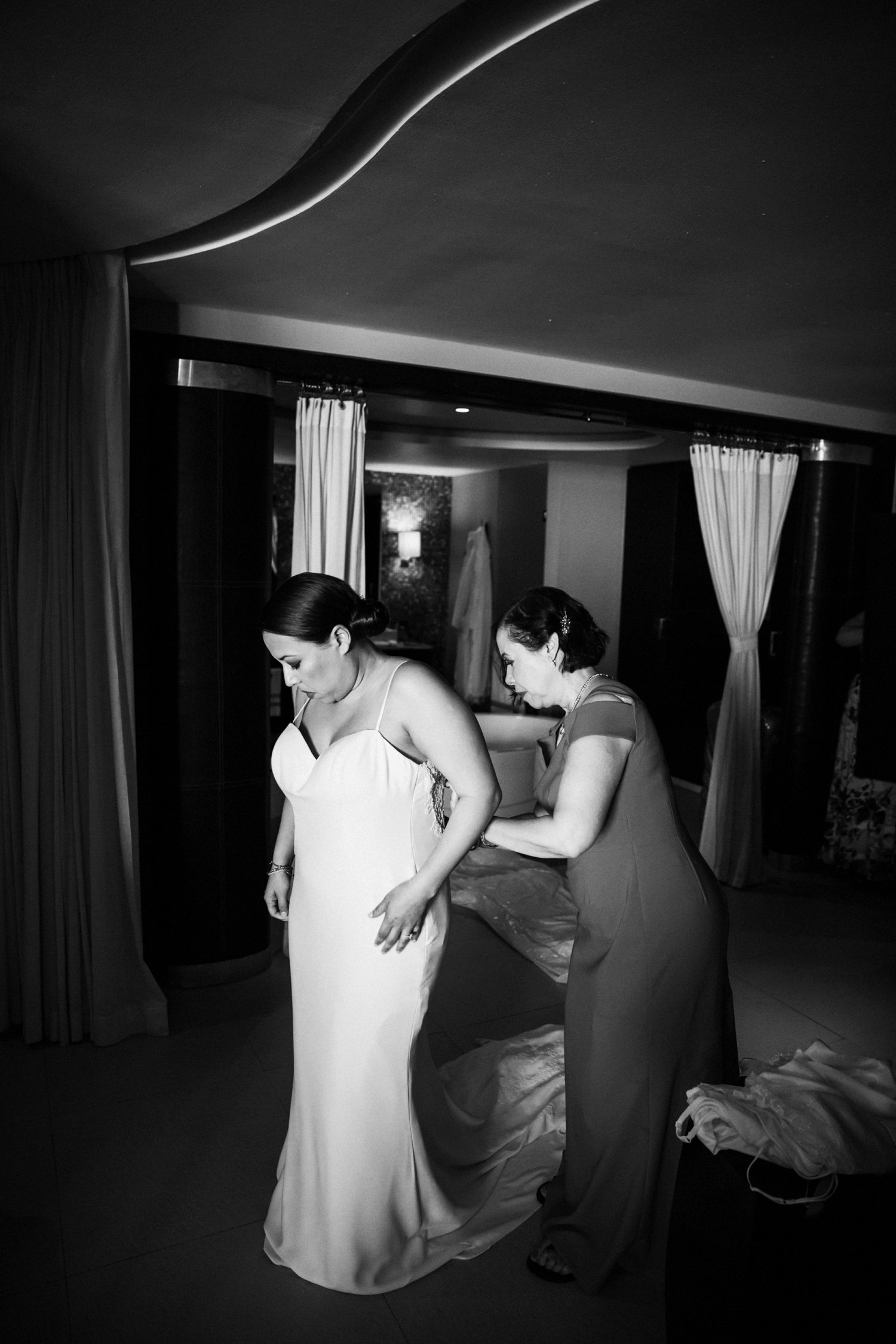  images by feliciathephotographer.com | destination wedding photographer | mexico | tropical | fiji | venue | azul beach resort | riviera maya | getting ready | details | black and white | putting on the dress | mother of the bride | jaehee atelier | pre-ceremony | 
