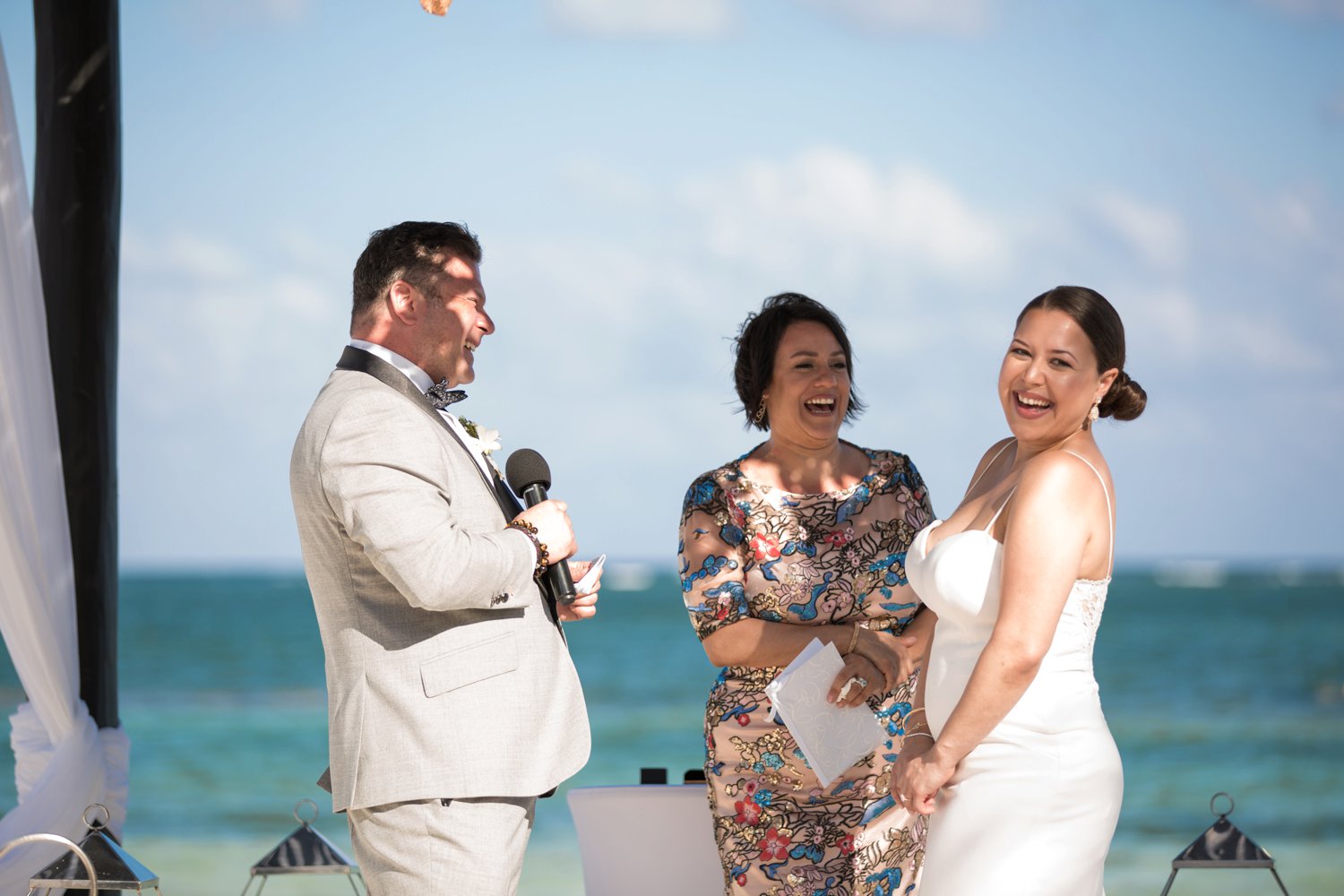  images by feliciathephotographer.com | destination wedding photographer | mexico | tropical | fiji | venue | azul beach resort | riviera maya | ceremony | oceanside | blue water | grey suit | white sheath gown | laughter | exchanging vows | joy | jaehee bridal atelier | 