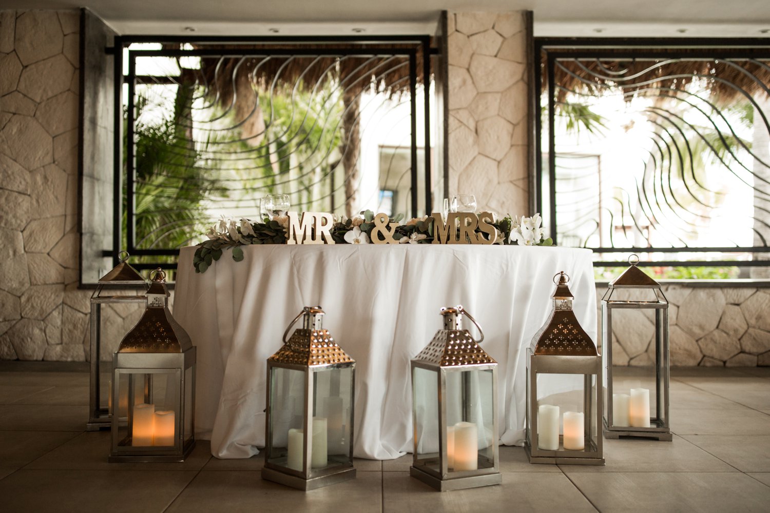 images by feliciathephotographer.com | destination wedding photographer | mexico | tropical | fiji | venue | azul beach resort | riviera maya | reception | details | head table | gold and white | candles | palm trees | 