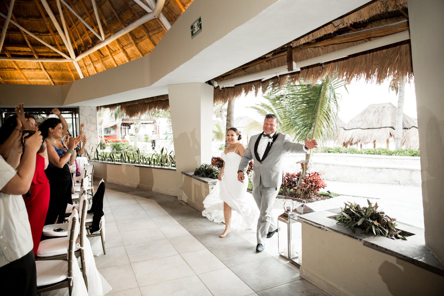  images by feliciathephotographer.com | destination wedding photographer | mexico | tropical | fiji | venue | azul beach resort | riviera maya | reception | first entrance | bride and groom | barefooted | 