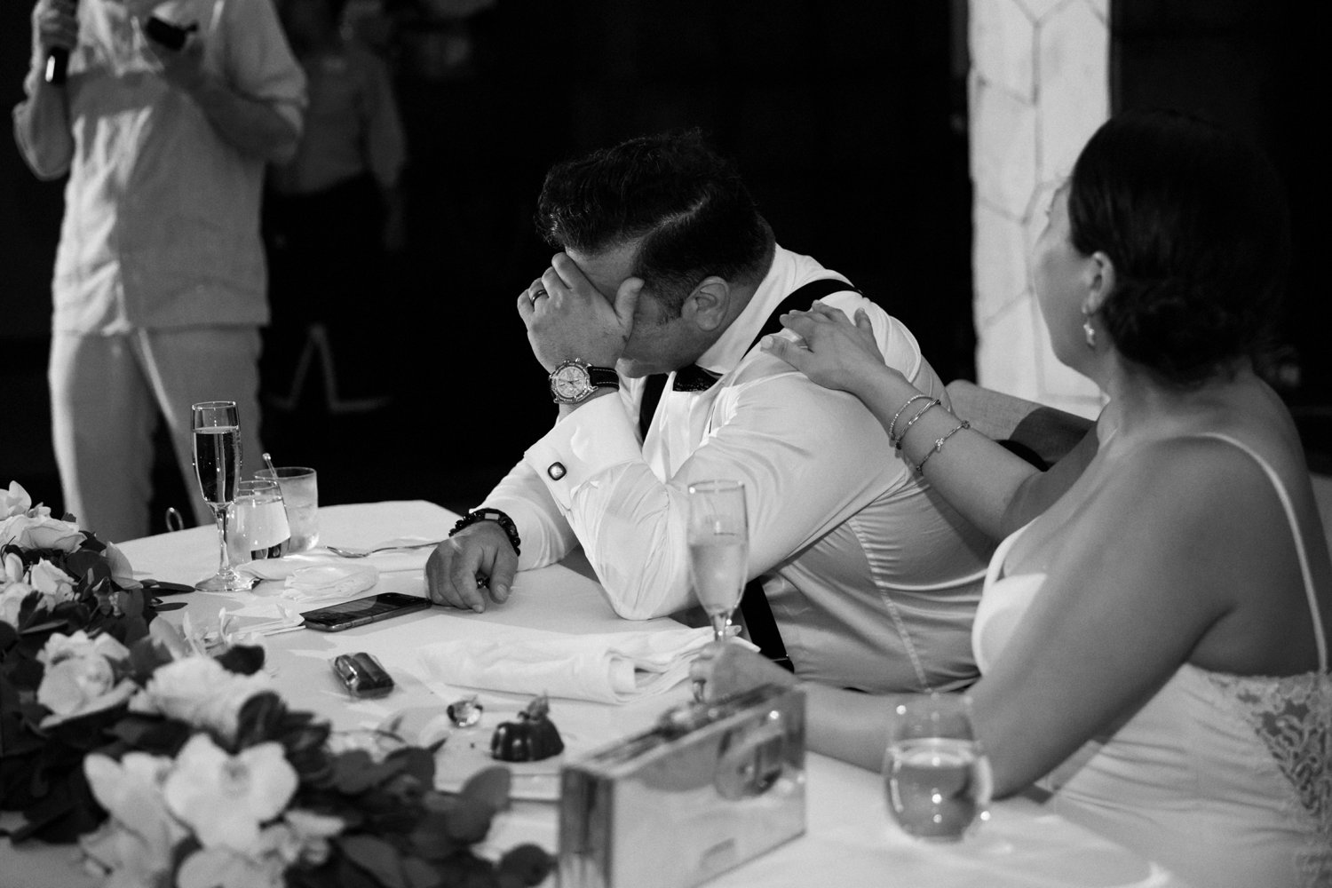  images by feliciathephotographer.com | destination wedding photographer | mexico | tropical | fiji | venue | azul beach resort | riviera maya | reception | black and white | bride and groom head table | tearing up | best man speech | toasts | champagne | 