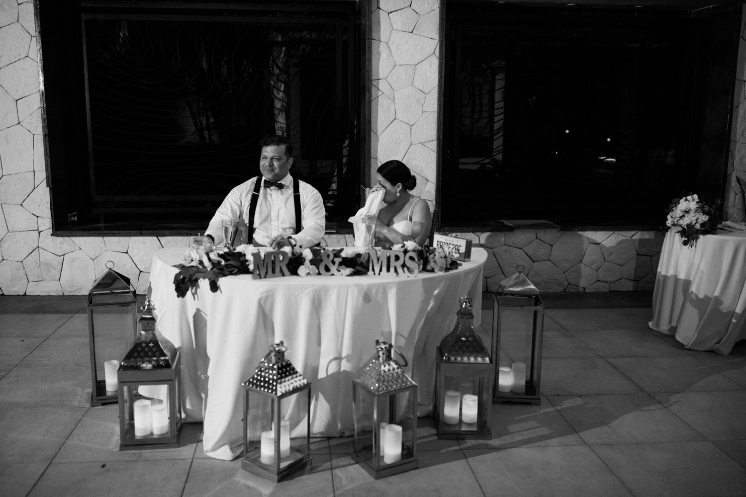  images by feliciathephotographer.com | destination wedding photographer | mexico | tropical | fiji | venue | azul beach resort | riviera maya | reception | speeches | bride and groom | head table | tearing up | mr and mrs | candles | black and white | 