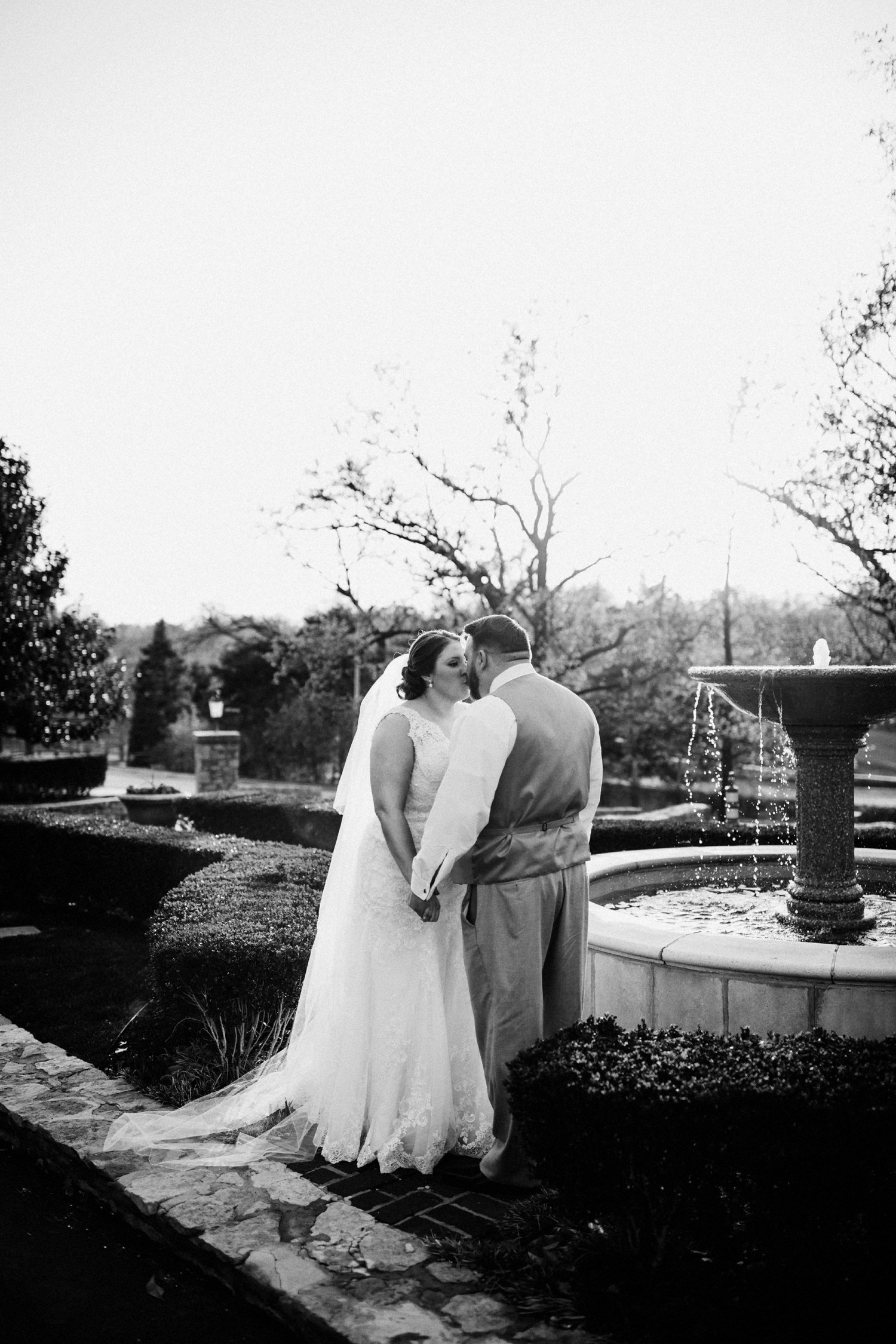  images by feliciathephotographer.com | destination wedding photographer | spring time | carriage club | exclusive | golden hour | bridal portraits | sunset | grey suit | jos a bank | white beaded lace dress | long veil | stella york | fountain | black and white | 