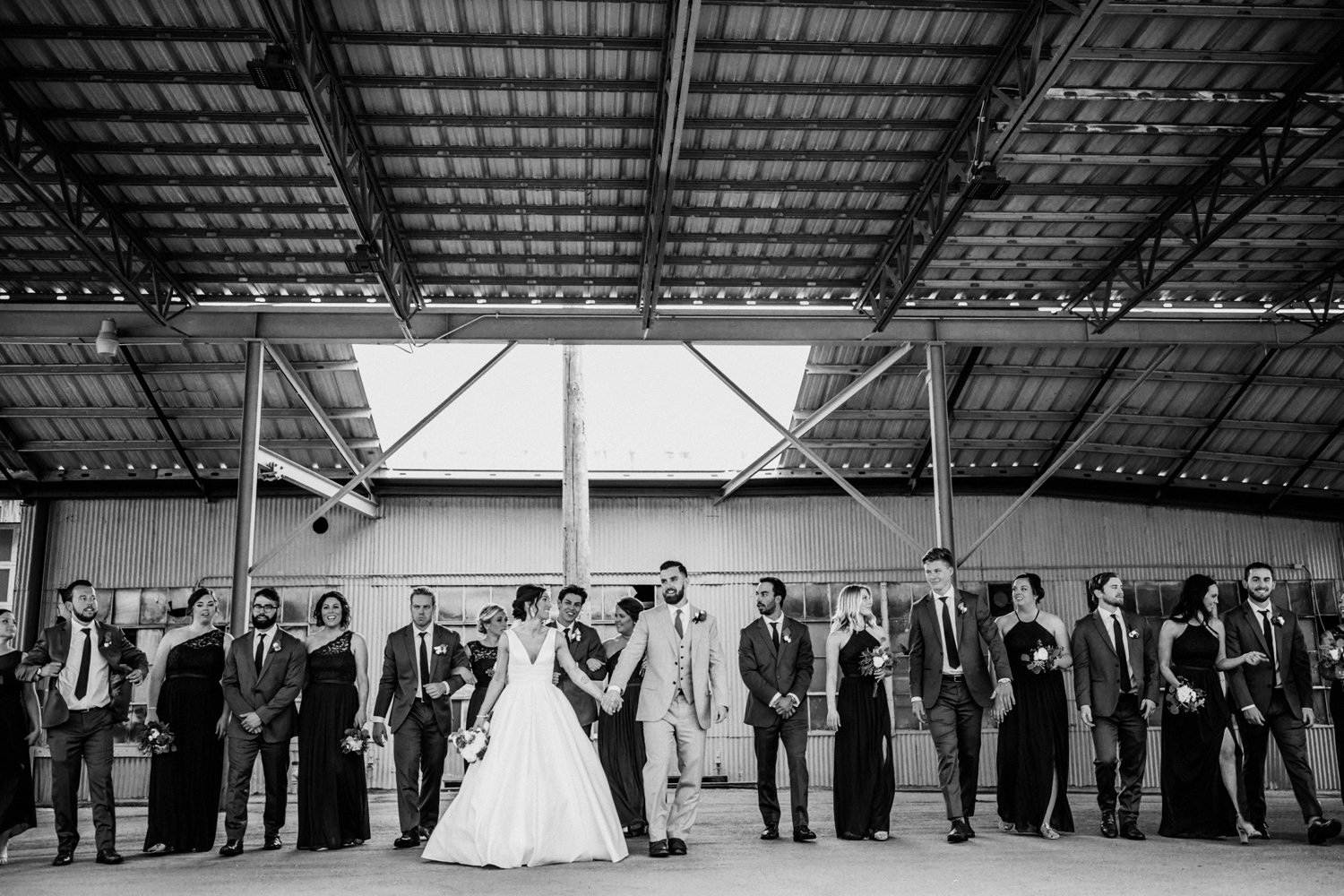  images by feliciathephotographer.com | destination wedding photographer | kansas city | spring time | bridal party | black and white | best friends | family | candid | satin a line dress | david's bridal | grey suits | the black tux | candid | industrial | modern | warehouse | 