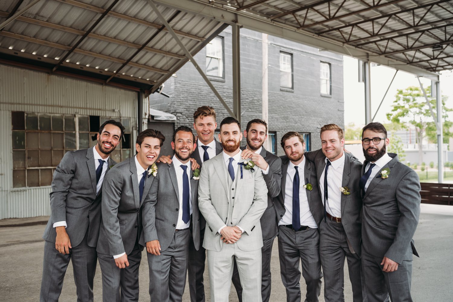  images by feliciathephotographer.com | destination wedding photographer | kansas city | spring time | groomsmen | silly | portraits | blue striped socks | grey suits | the black tux | navy tie | industrial | modern |