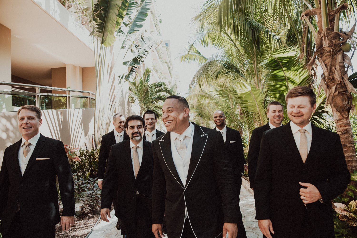  images by feliciathephotographer.com | destination wedding photographer | el dorado riviera maya | glamorous | beachside | resort | groomsmen | candid | the black tux | gold ties | palm trees | tropical | 