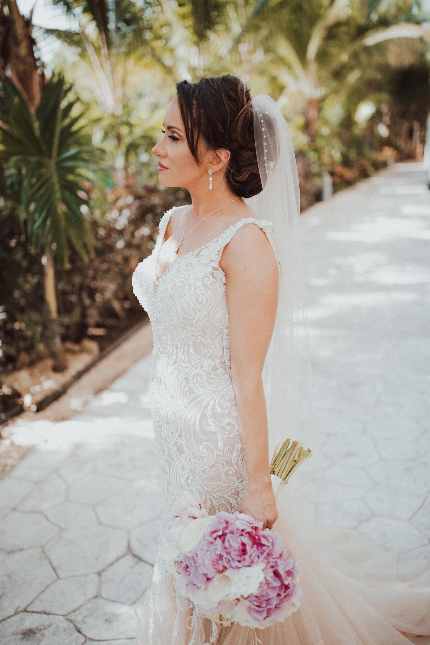  images by feliciathephotographer.com | destination wedding photographer | el dorado riviera maya | glamorous | beachside | resort | bride | beaded dress | pearl edged veil | pink and white bouquet | tropical | candid | allure | 