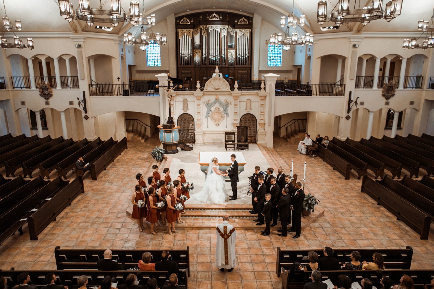  images by feliciathephotographer.com | destination wedding photographer | kansas city | summertime | classic | ceremony | visitation church | catholic | symmetry | chandelier | bride and groom | organ | 