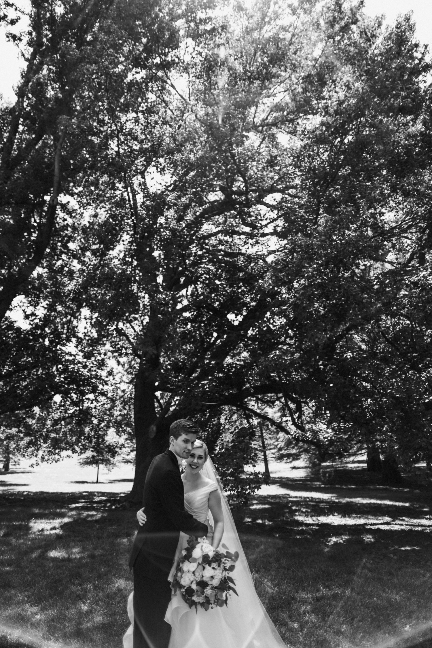  images by feliciathephotographer.com | destination wedding photographer | kansas city | summertime | classic | couple portrait | black and white | bride and groom | loose park | oak trees | mens warehouse | gown gallery | wild hill | 