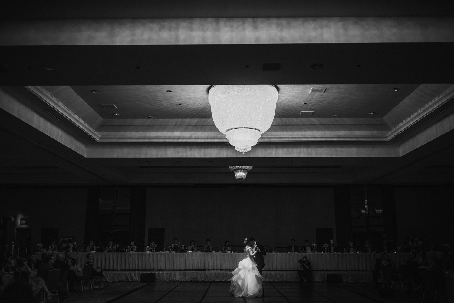  images by feliciathephotographer.com | destination wedding photographer | kansas city | summertime | classic | first dance | the gown gallery | full skirt | tuxedo | mens warehouse | black and white | glamorous chandelier | 