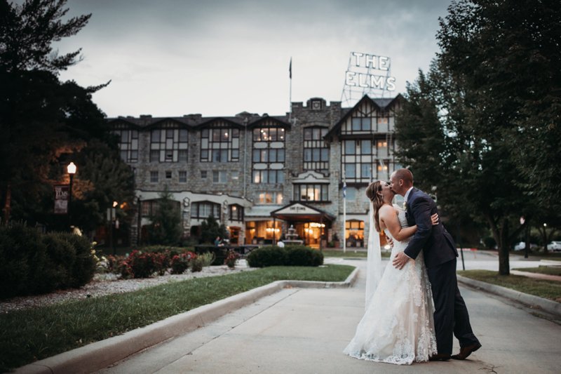  images by feliciathephotographer.com | destination wedding photographer | kansas city | summertime | elms spa | classy | couple portrait | bride and groom | navy suit | jos a bank | lace gown | sweetheart neckline | dress gallery wichita | hand in hand | golden hour | sunset | true love | kiss | 