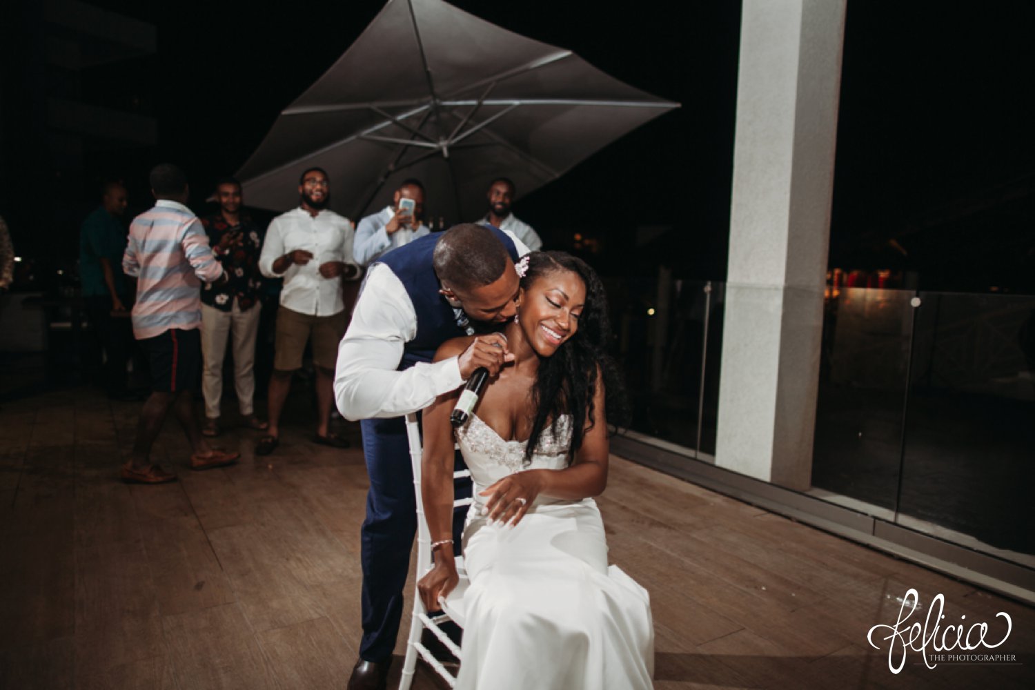   images by feliciathephotographer.com | destination wedding photographer | st lucia | l&s travel | the Royalton | reception | details | groom serenading bride | throwing the garter | white fitted gown | navy suit | 