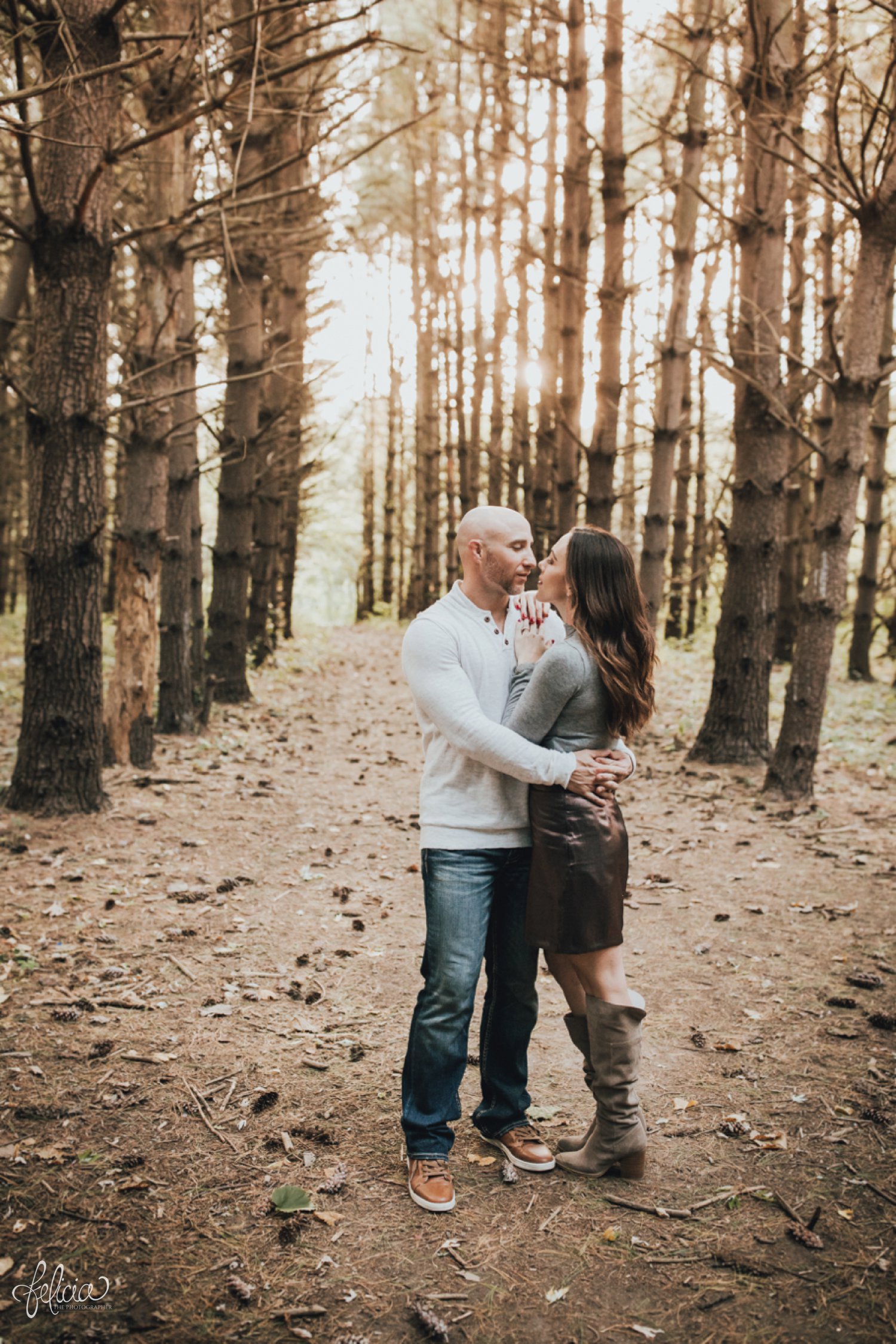 images by feliciathephotographer.com | destination wedding photographer | family portraits | fall attire | autumn | woodland setting | forest | casual | jeans | corduroy | sparkly boots | fur vest | toddlers | hipster | playful | parents and kiddos | father mother | lumber | kiss | couple | 